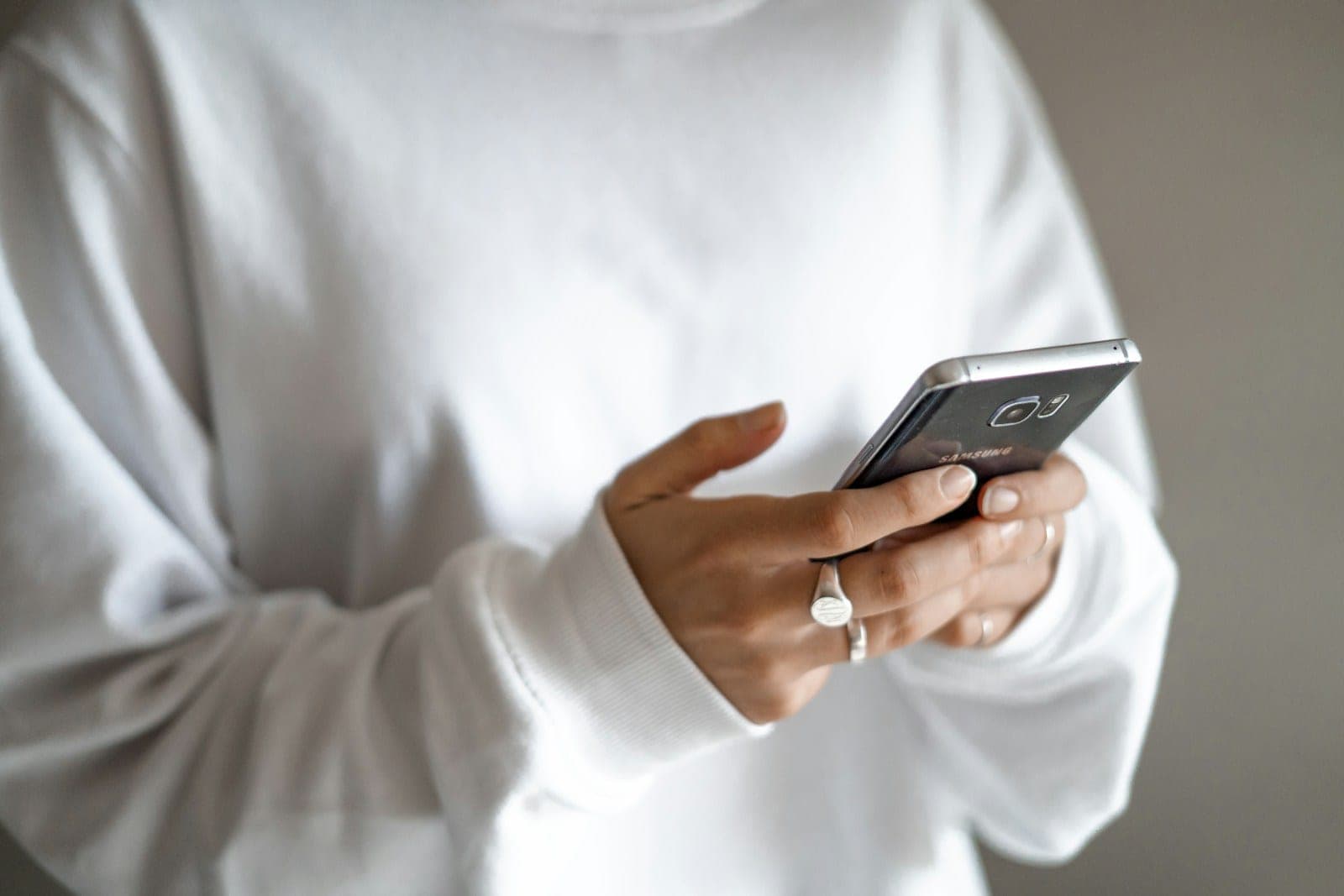 A business owner replying to customer messages on a phone