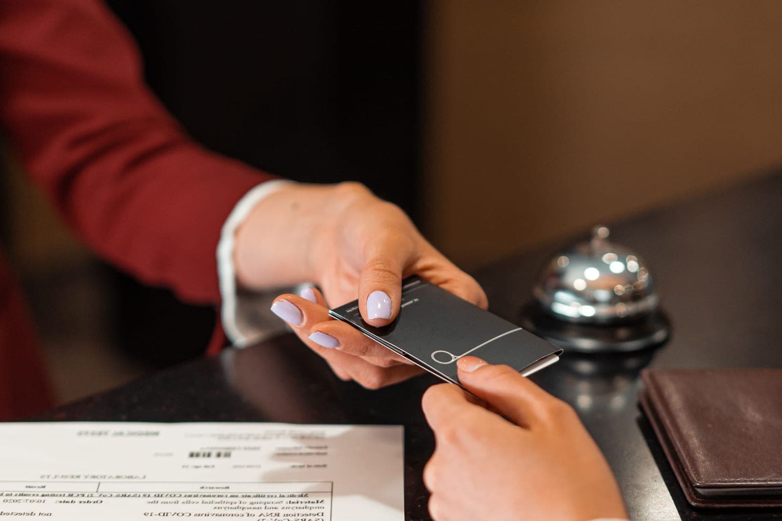 Hotel front desk staff checking in a guest