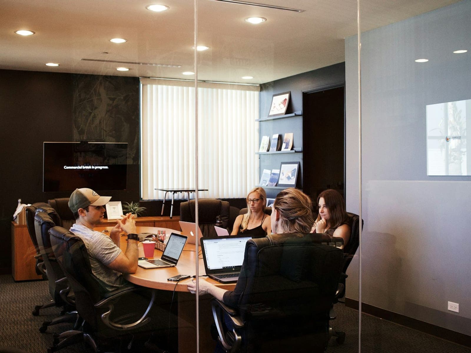 Colleagues reviewing results together at a table with a laptop