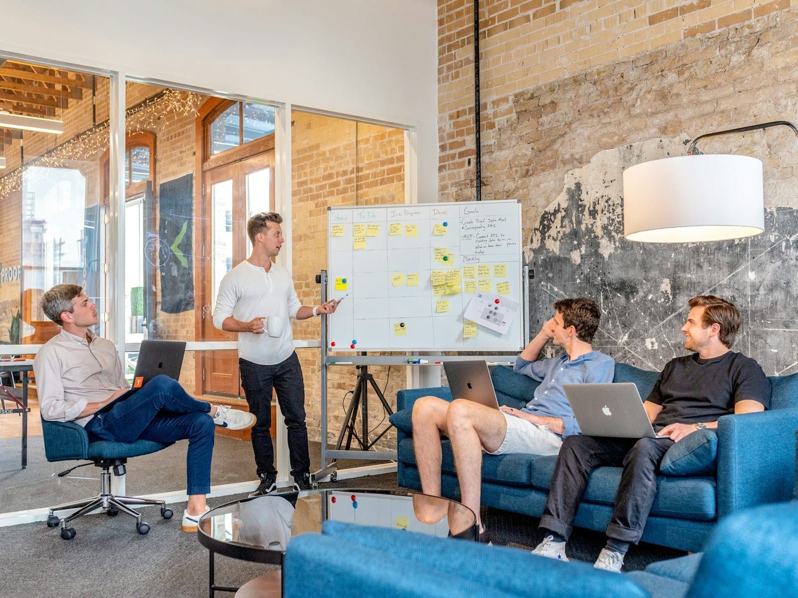 A team working through a plan at a whiteboard