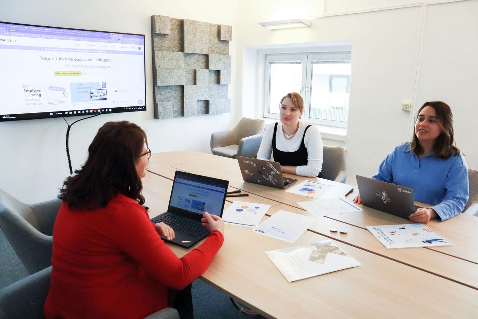 A marketing team reviewing campaign results together at a conference table