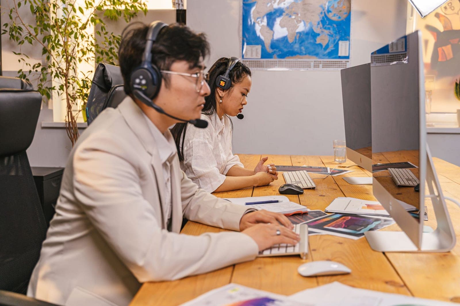 A customer support specialist answering messages at a modern desk