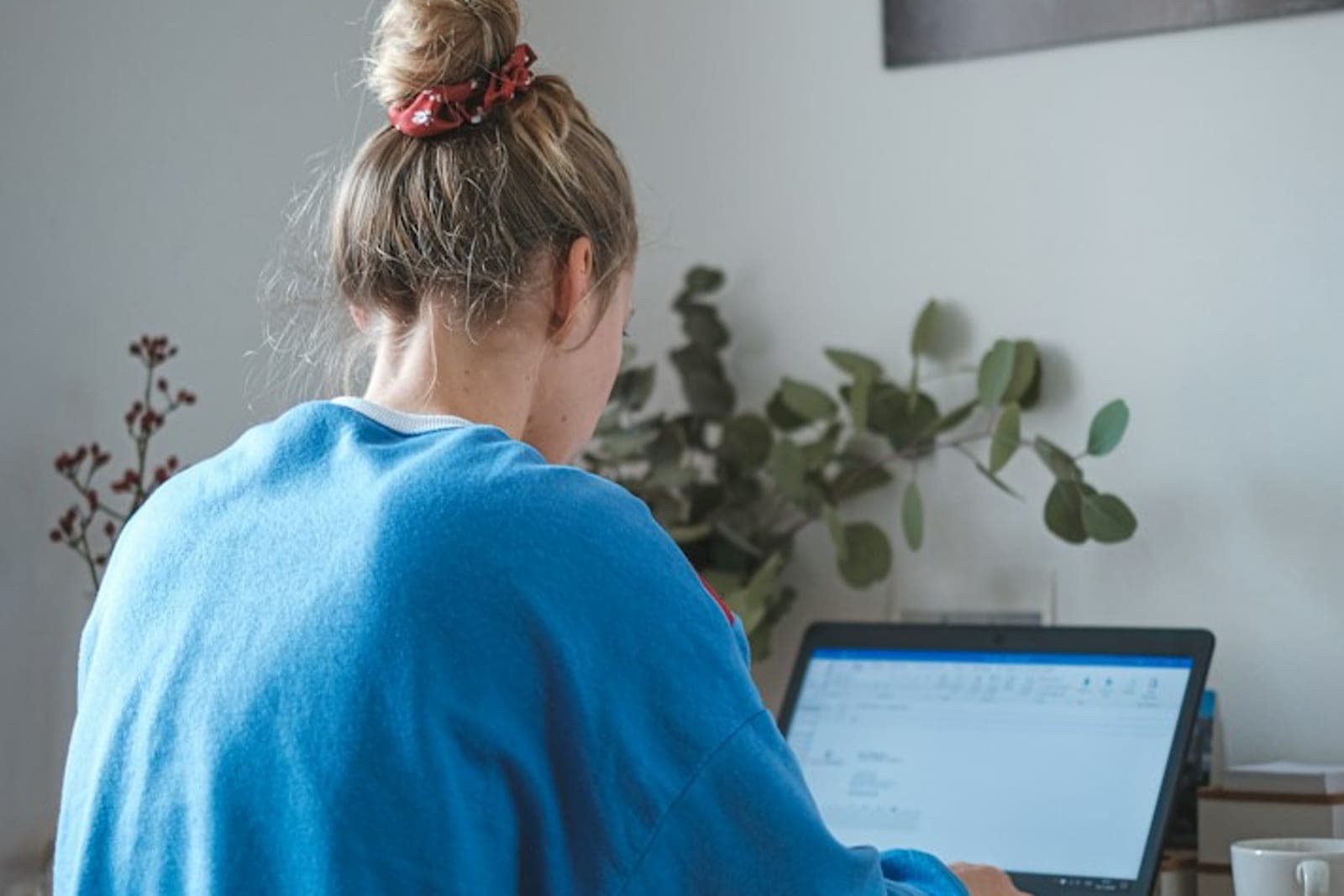 A designer building a website layout on a laptop