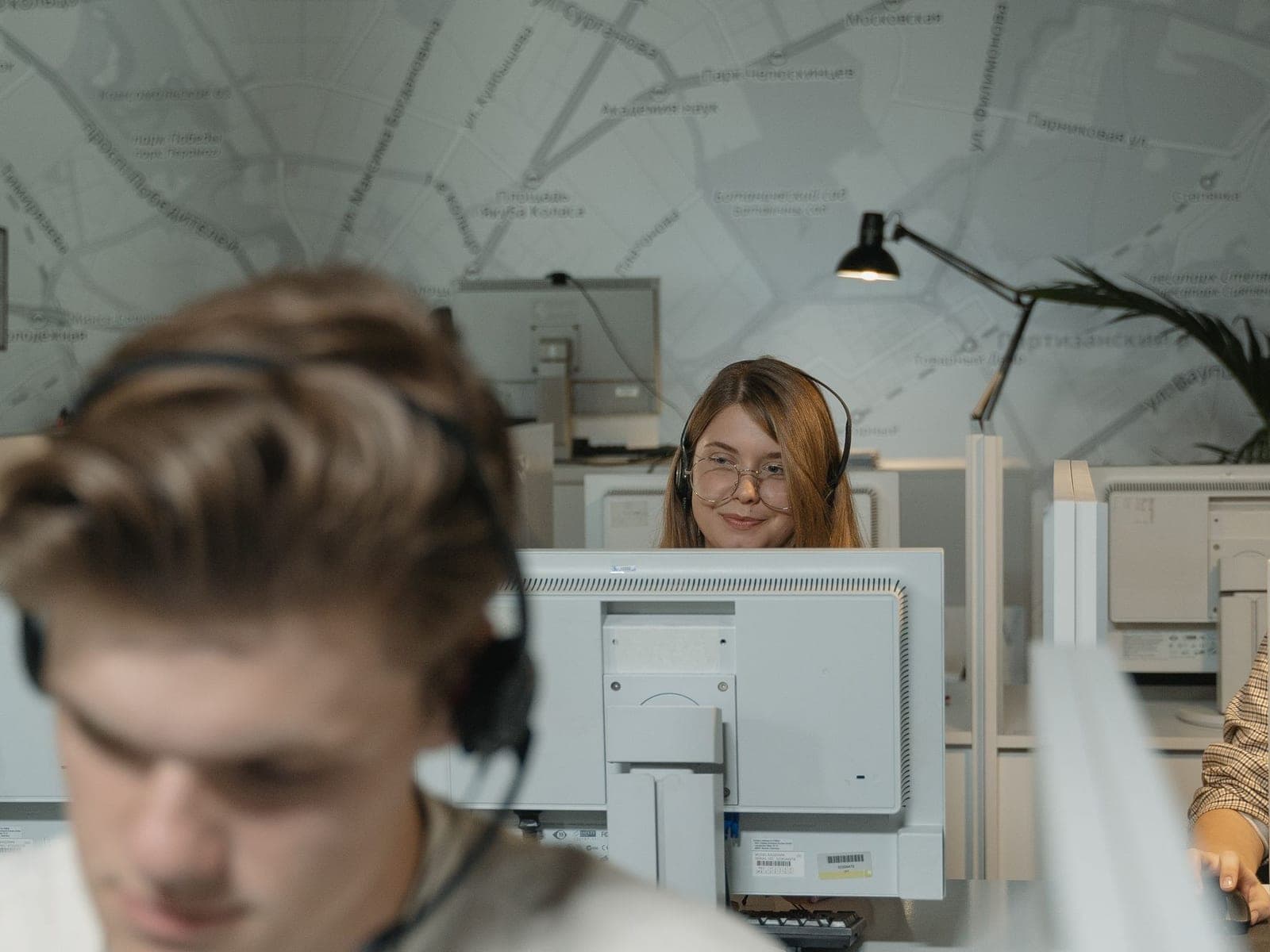 Customer support agents answering messages at their desks