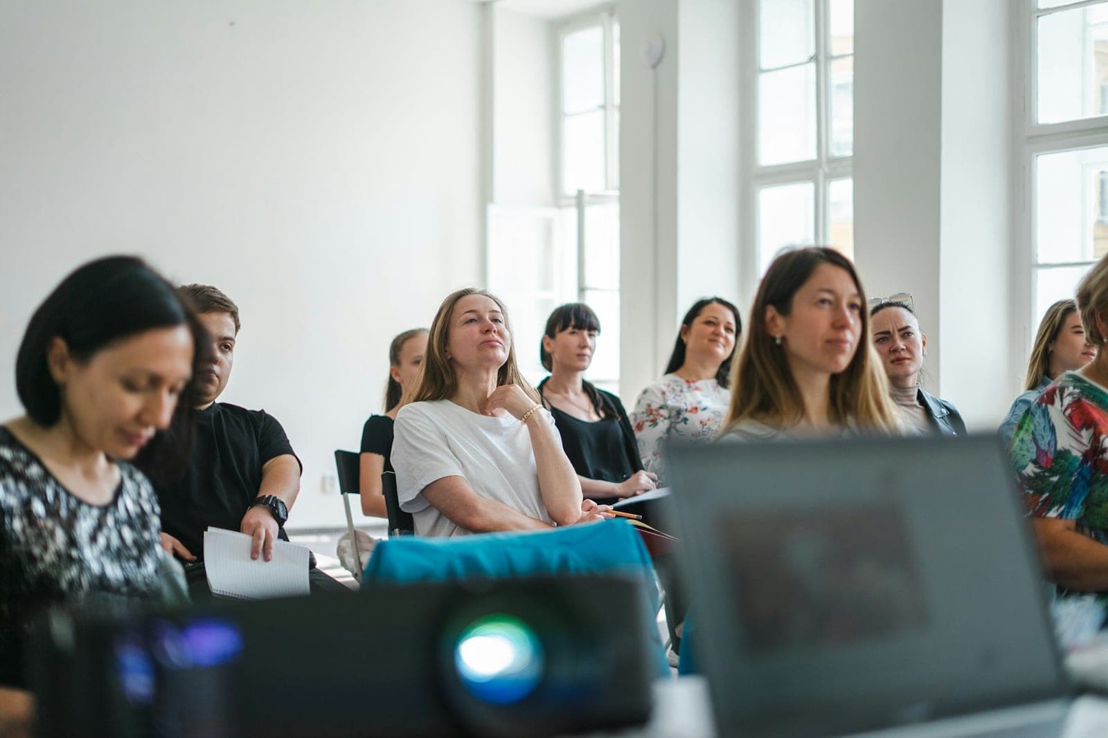 Adults attending a hands-on workshop in a bright, sunlit room